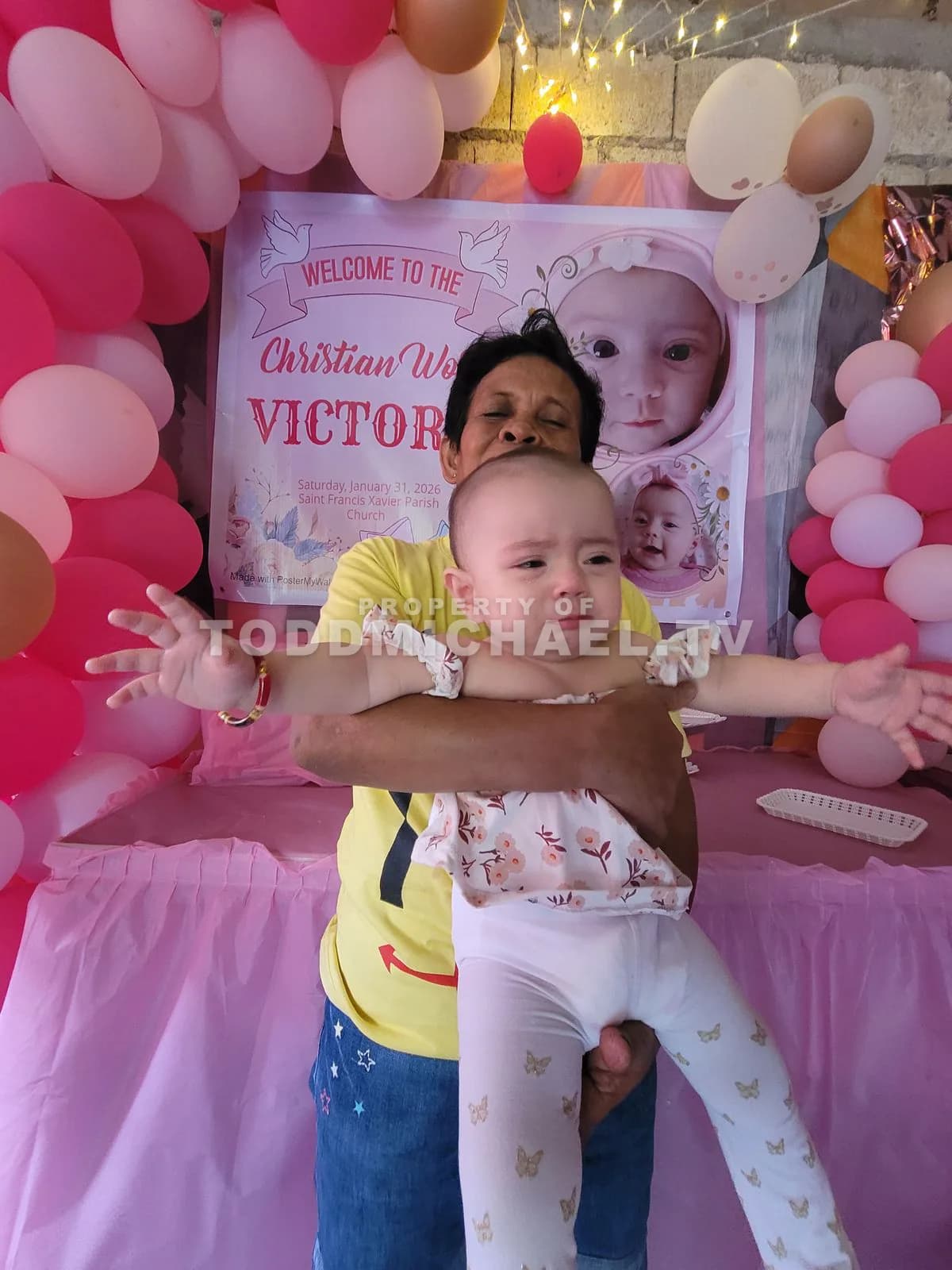 A family celebrating a birthday with balloons and decorations.