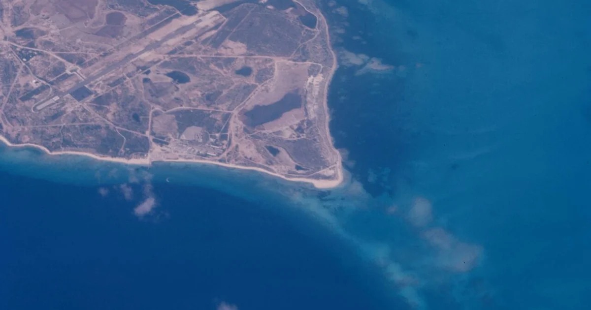 Aerial view, taken above clouds, of Florida's southern tip coastline over Fairchild Tropical Botanical Gardens in Coral Gable, Miami-Dade County.1 photograph : positive, col. ; 4 x 4 cm.