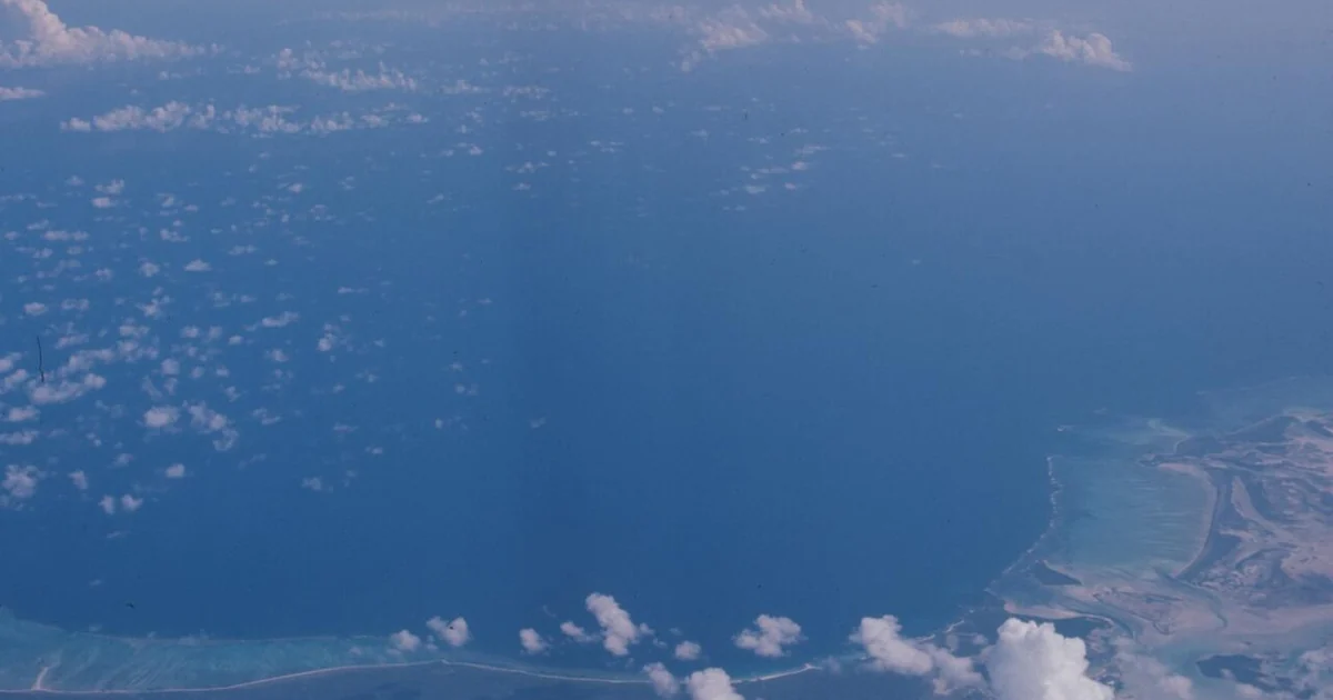 Aerial view, taken above clouds, of Florida's coastline in Coral Gable, Miami-Dade County over Fairchild Tropical Botanical Gardens.1 photograph : positive, col. ; 4 x 4 cm.